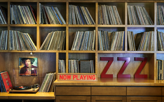 hotel ziggy front desk bookshelf with albums and record player