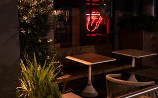 hotel ziggy patio view and red neon sign of mouth with tongue sticking out hanging on the wall