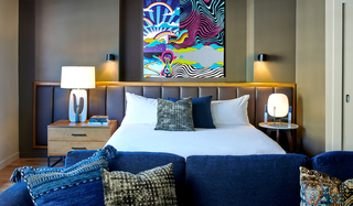 hotel ziggy guestroom with bed and blue sofa