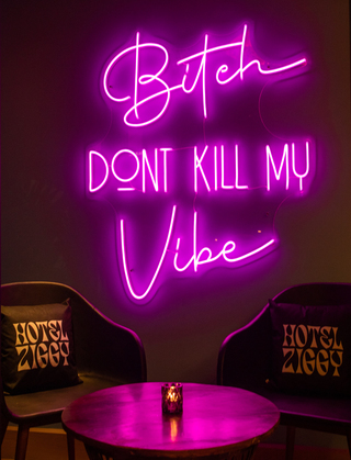 hotel ziggy pink neon sign saying bitch don't kill my vibe