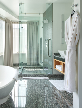 w boston bathroom featuring a white bathtub and glass shower