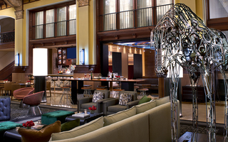 union station nashville lobby bar, seating, and a metal horse sculpture displayed in the back of the sofa