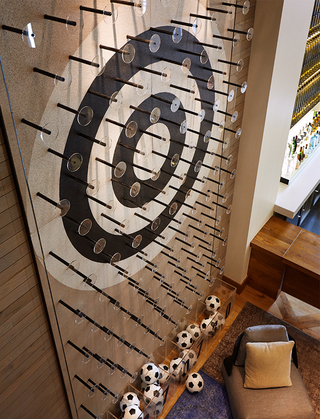 hotel zetta view of bull's eye wall and soccer balls on the ground floor of plinko room