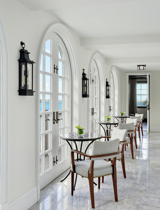 rosewood bermuda conservatory bar hallway featuring the indoor seating next to the juliet balconies