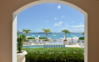 rosewood bermuda outdoor arched way with a view of the R shaped pool and terrace looking over the ocean