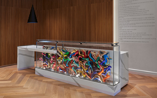 hotel zena lobby reception desk featuring heels of all colors and materials displayed in the glass case of the desk