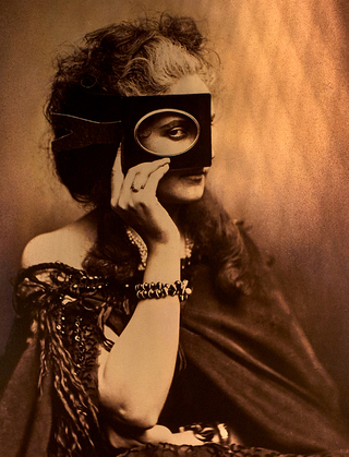 dirty habit dc close up of a bronze mural with a woman at center holding an oval frame to her eye