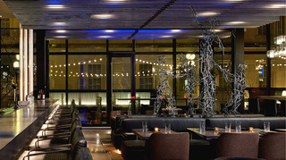 dirty habit dc silver metal sculptures are intertwined and displayded in the middle of the restaurant seating area