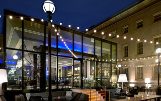 dirty habit dc view of the exterior structure of the glass windowed restaurant and outdoor patio seating