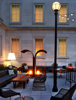 dirty habit dc outdoor patio seating surrounding the metal fireplace