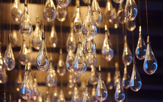 w la detailed shot of the numerous teardrop bulbs that's hanging on the ceiling in the lobby lounge