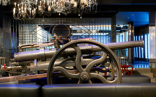 revere hotel rebel's guild antique canon displayed in between the leather seating in the restaurant