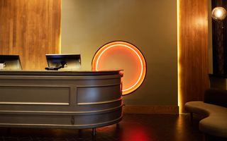 hotel zelos reception desk and 7orange neon light installation