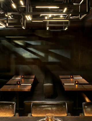 dirty habit sf liquor glasses on the bar wooden table facing out to the restaurant tables