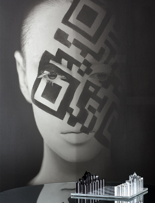 hotel zelos close up of the mural of a woman with a QR code painted across her face