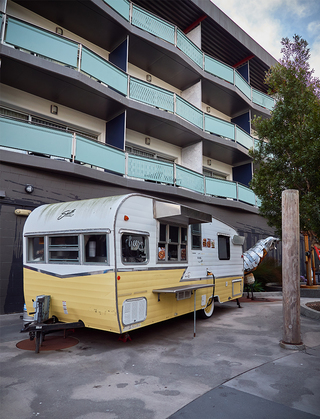 hotel zephyr outdoor trailer with a view of the hotel room balconies in the background