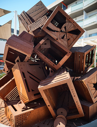 hotel zephyr close up of the metal tv sculptures stacked in a fireplace