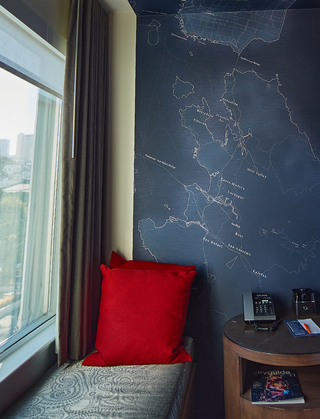 hotel zephyr guestroom blue map wallpaper of San Francisco running to the right of the window seating and up to the ceiling