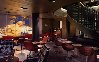 hotel vintage portland mural of a built goddess hangs in the lobby lounge