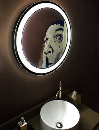 hotel vintage portland bathroom image of the sink and ring light mirror. In the mirror reflection, the mural on the bathroom wall of a man doing the shush gesture shows up in the corner of the frame