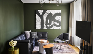 Hotel zeppelin suite living room decorated with the painted 'yes' mural on the wall, leather furniture to the left and tv to the right