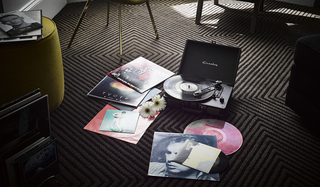 hotel zeppelin record player and records scattered on the guestroom floor