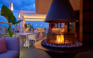 hotel zena outdoor fireplace in the middle of an abundance of outdoor seating