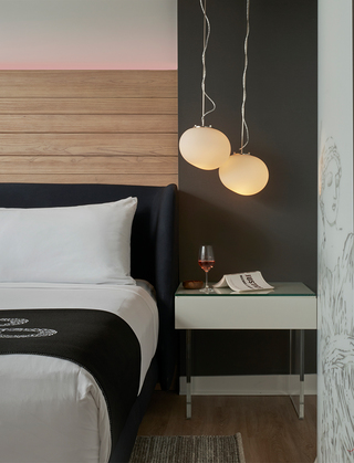 hotel zena guestroom nightstand with a column to the right displaying a graphic of a greek goddess