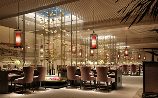 Gemstone International Resort restaurant featuring dining tables and skylight windows with flower installations hanging from the ceiling