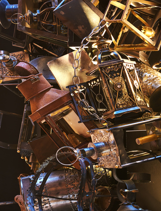 revere hotel close up of the lobby ceiling installation showing the cluster of metal items hanging from the ceiling