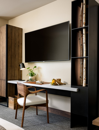 1 hotel sf desk with wood detail beside a television screen