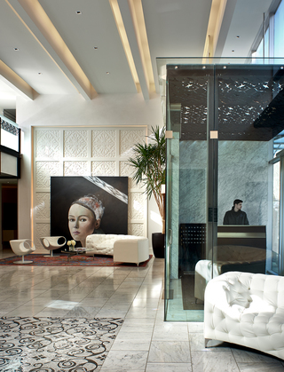 the fontaine lobby featuring the glass window entry way and a large portrait of a woman on the wall
