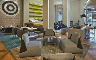 hotel zetta view of the lobby seating, plinko room wall, and liquor bottles displayed in the S&R lounge